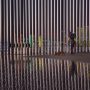 Photo: Daniel Ochoa de Olza Associated Press Une femme se promène sur le flanc mexicain de la clôture frontalière qui sépare San Diego, aux États-Unis, et Tijuana, au Mexique. 